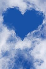Clouds in the sky surround a blue-sky heart
